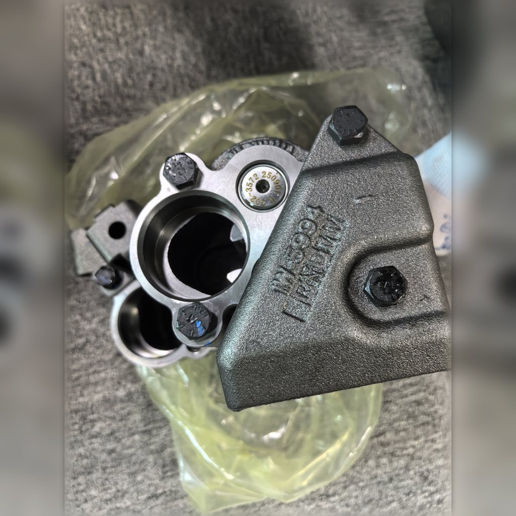 1614110 Engine Oil Pump Group - close-up of the pump ports on protective wrapping