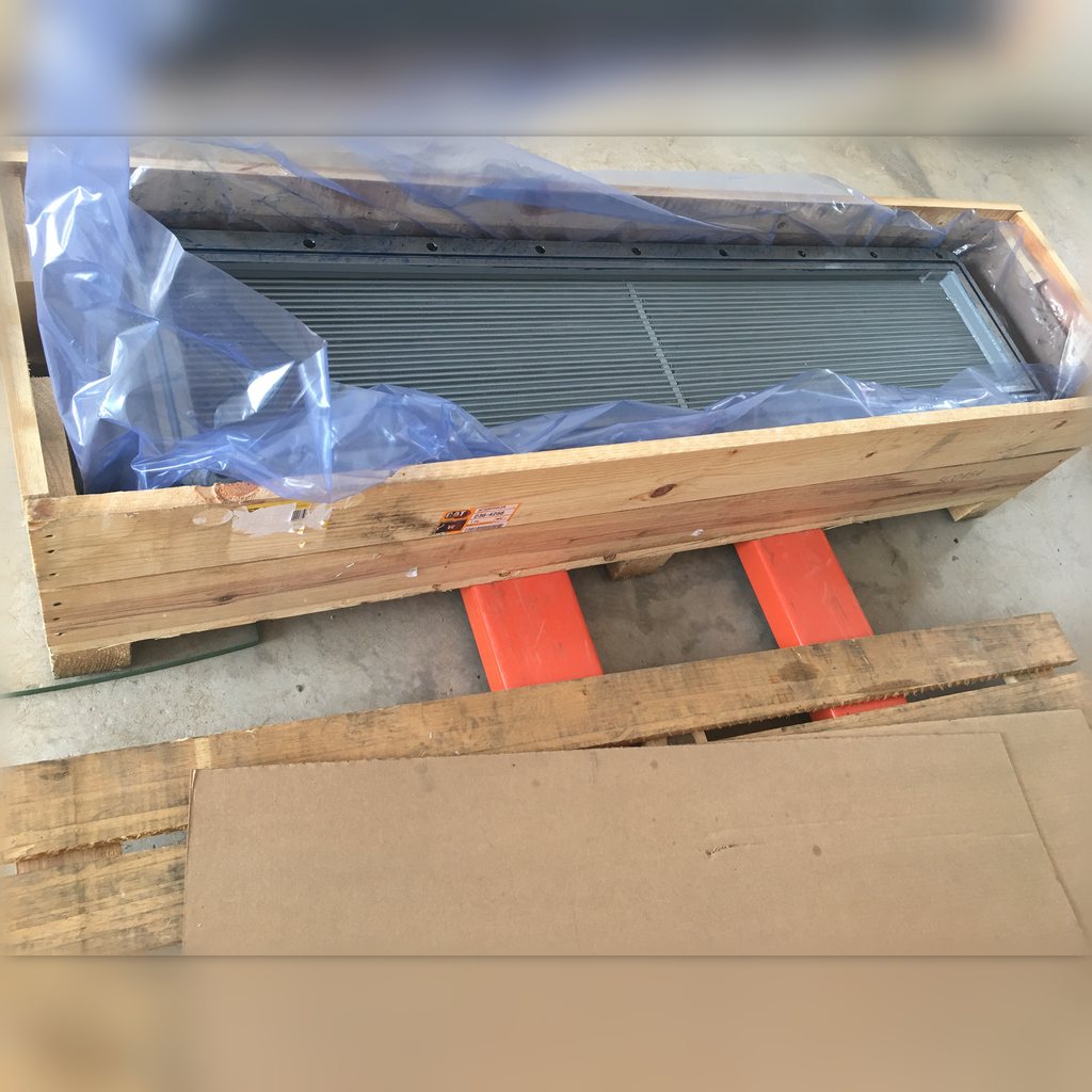 2364256 Aftercooler Core Assembly - open crate revealing the long finned core