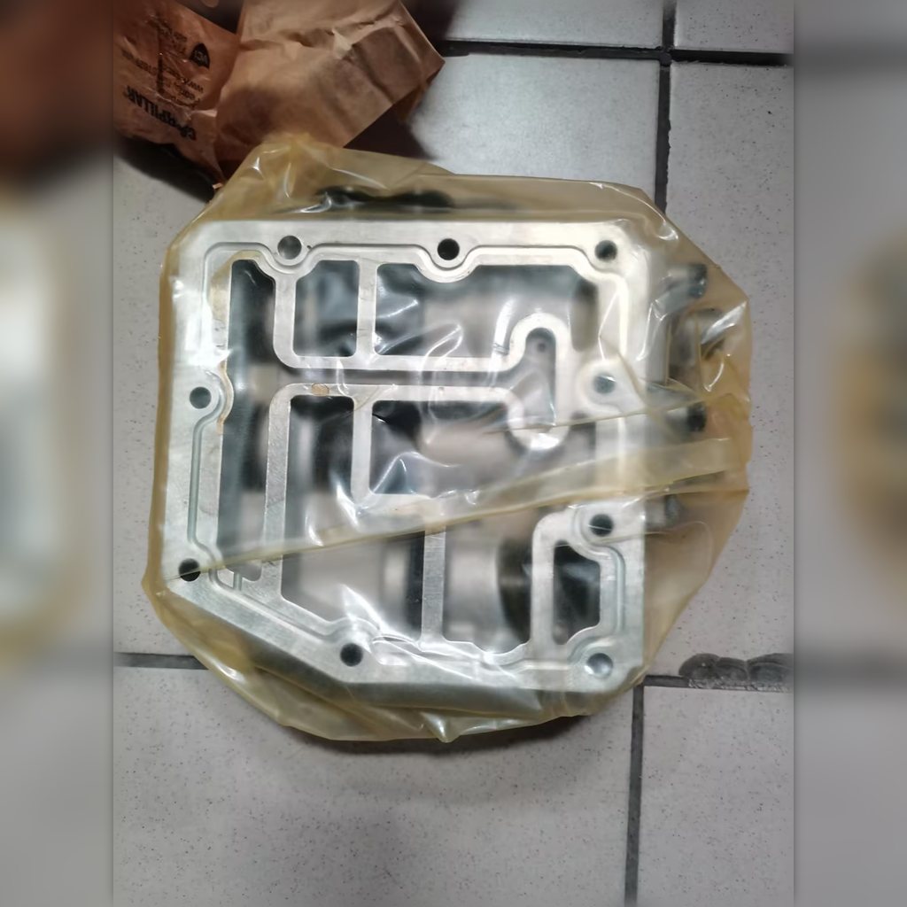 3049025 Relief Valve Group - mounting face and channels inside clear packaging