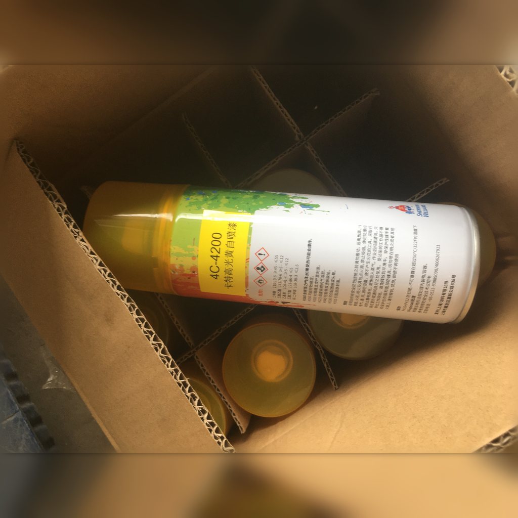 4C4200 Yellow Paint - paint can lying across packing material