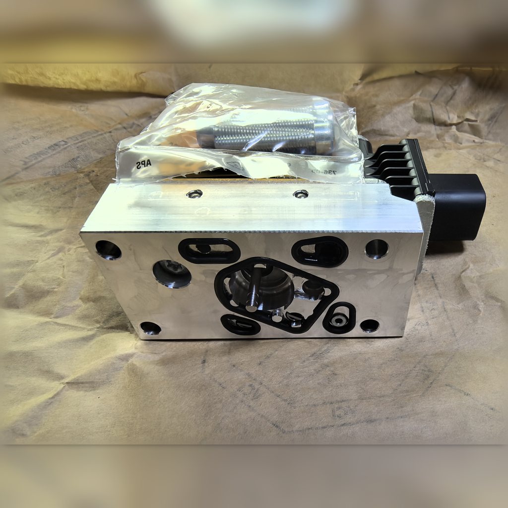 5593552 Actuator Valve Group - metal valve block showing circular ports